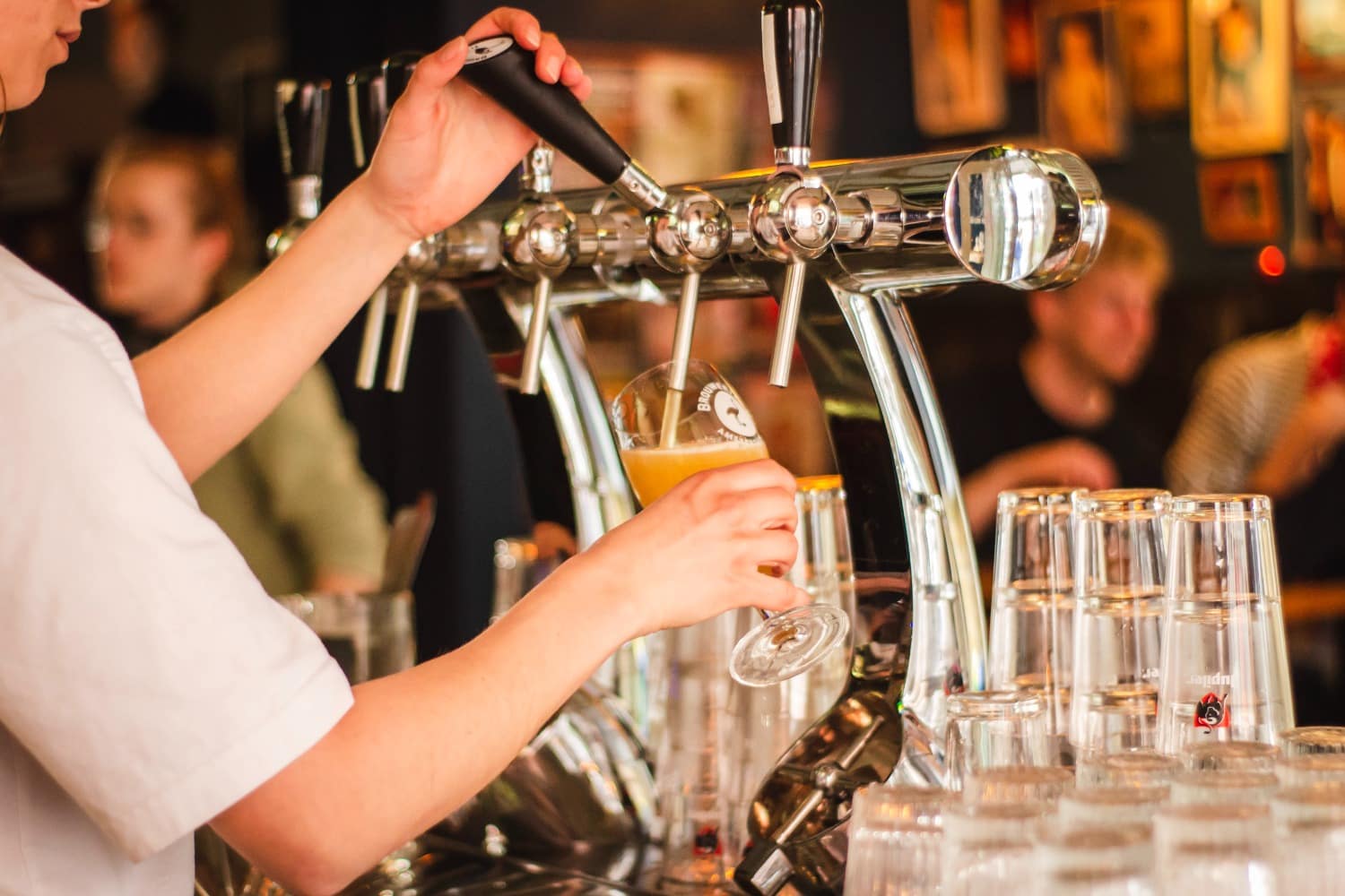 bartender pouring beer from tap