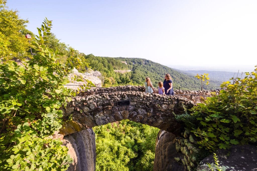 seeRockCity family walks across bridge at Rock City