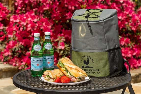 sandwich and hiking backpack with two drinks at chanticleer inn