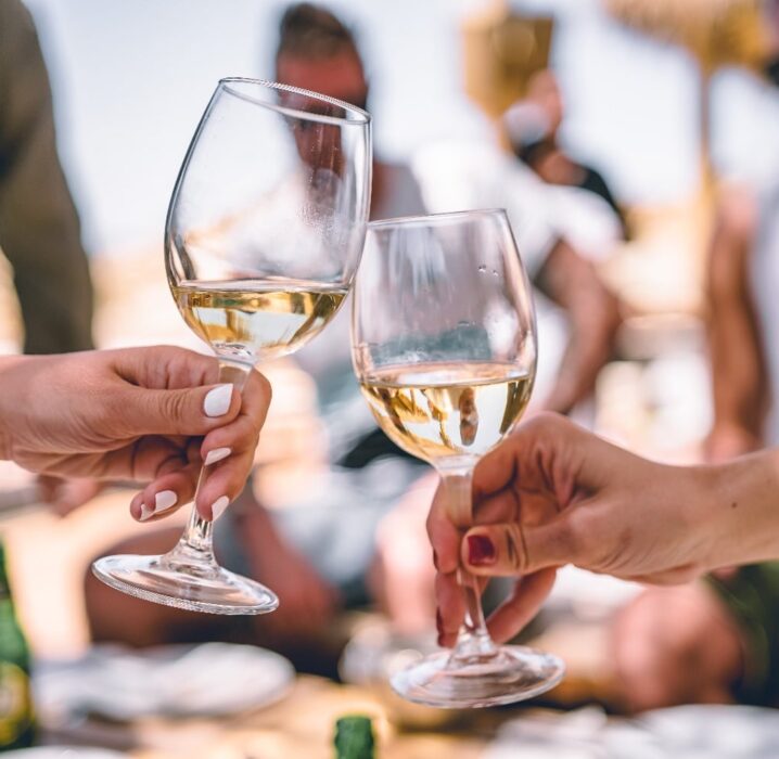 white wine glasses cheers outdoors