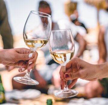 white wine glasses cheers outdoors