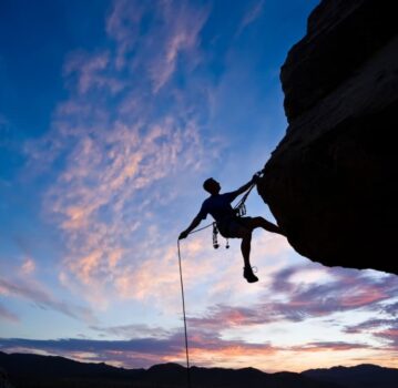 rock climber profile with sunset in background
